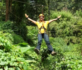 guest enjoying the zipline adventure at Vythiri Village Resort Day Out Package, Wayanad